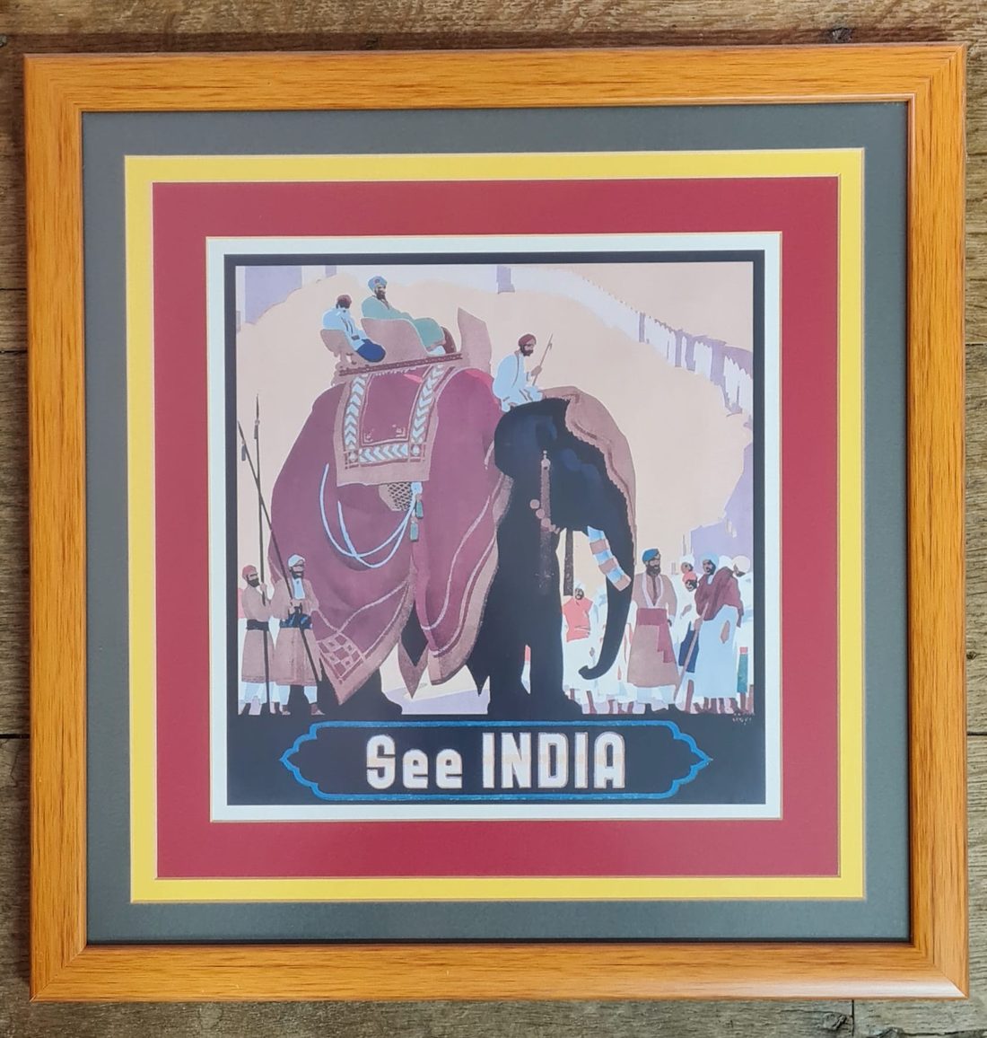 Travel poster, oak moulding with a deep-red, gold and slate triple mount.